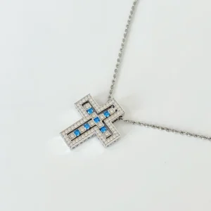 Layered sterling silver cross necklace: Rhodium-plated openwork cross with clear diamonds suspending blue gemstone cross on 17.7" rope chain, RSL compliant
