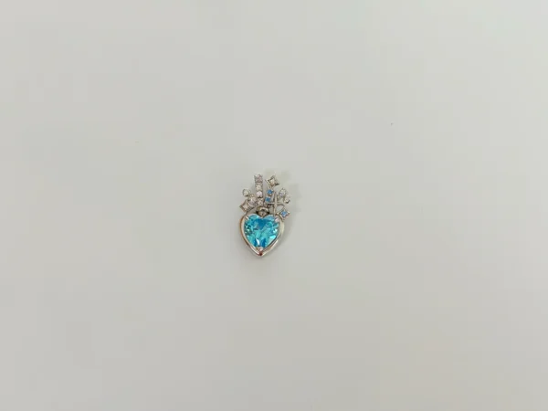 Sky blue 5A cubic zirconia heart pendant in rhodium-plated sterling silver with halo accent stones, RSL compliant jewelry