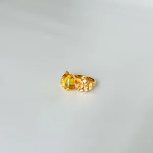 Detailed view of gold rings for women: 18k gold plated sterling silver gemstone ring featuring a warm golden oval-cut 5A cubic zirconia center stone with sparkling simulated diamond accents.