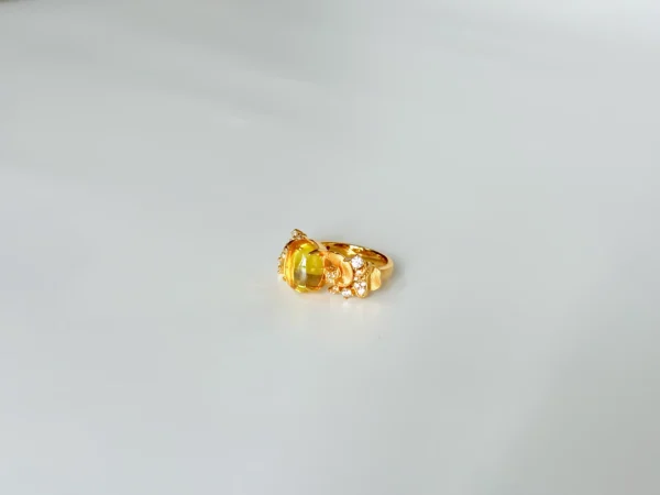 Detailed view of gold rings for women: 18k gold plated sterling silver gemstone ring featuring a warm golden oval-cut 5A cubic zirconia center stone with sparkling simulated diamond accents.